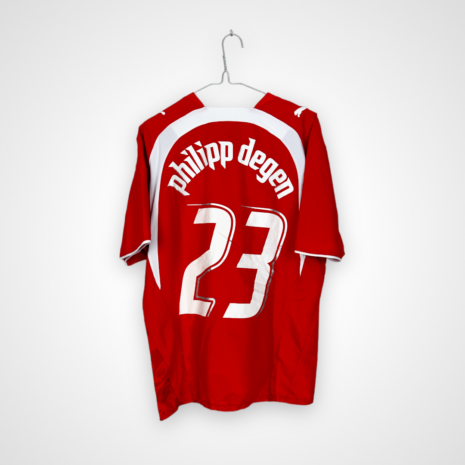 Koszulka piłkarska Szwajcaria, 2006/08 Home, stan dobry - delikatnie popękane cyfry, rozerwanie materiału na plecach oraz kilka mikro zaciągnięć.