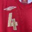 Koszulka piłkarska Anglia, 2006/08 Home, stan zadowalający - brak gwiazdki nad herbem, popękane logo umbro oraz zaciągnięcie pod kołnierzem na froncie.- widok