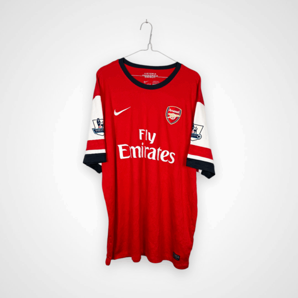 Koszulka piłkarska Arsenal FC, 2012/14 Home, stan bardzo dobry - mikro zaciągnięcie przy herbie oraz nieznacznie urwany szew.