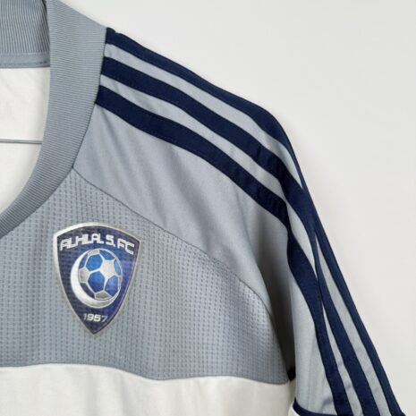 IMG_9742 Koszulka piłkarska AL Hilal SFC, 2010/11 Away, stan dobry - uszkodzony napis 'formotion', mikro pęknięcia wokół nadruku sponsora oraz jedno drobne zaciągnięcie.-
