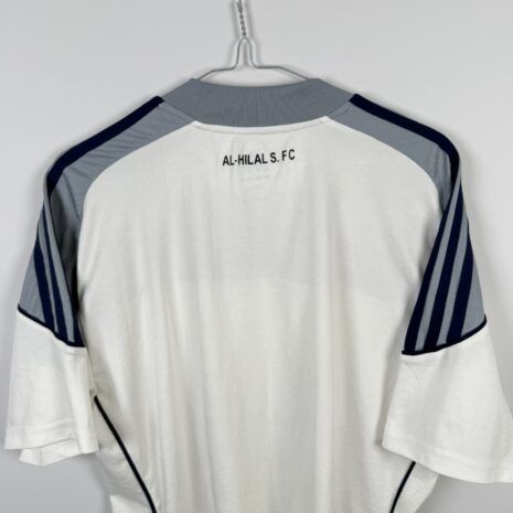 IMG_9747 Koszulka piłkarska AL Hilal SFC, 2010/11 Away, stan dobry - uszkodzony napis 'formotion', mikro pęknięcia wokół nadruku sponsora oraz jedno drobne zaciągnięcie.-